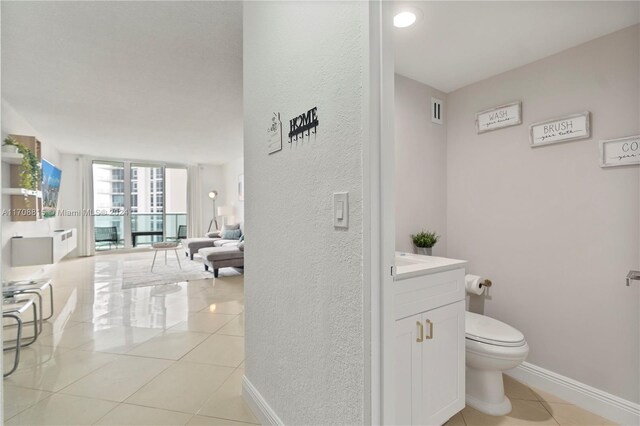 bathroom featuring toilet, vanity, and tile patterned floors