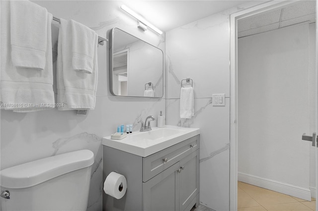 bathroom featuring tile patterned floors, vanity, and toilet