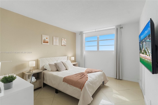 tiled bedroom with a textured ceiling