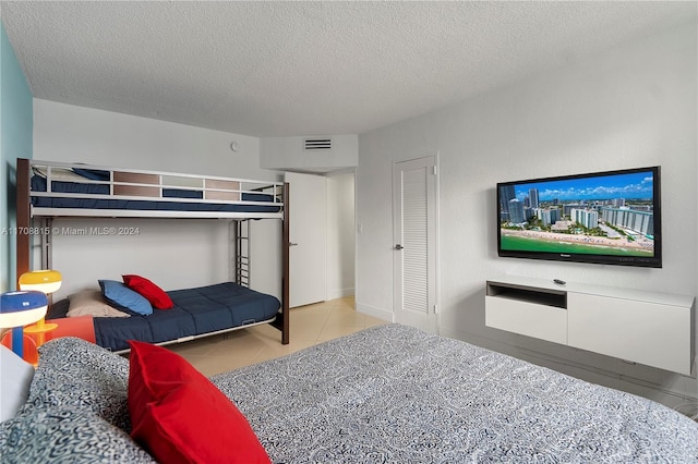 3901 S Ocean Dr Unit 15N, Hollywood, FL 33019 - tiled bedroom featuring a textured ceiling