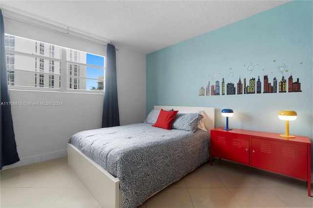 bedroom featuring tile patterned flooring and a textured ceiling