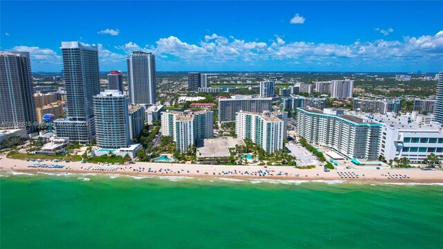 drone / aerial view featuring a beach view and a water view