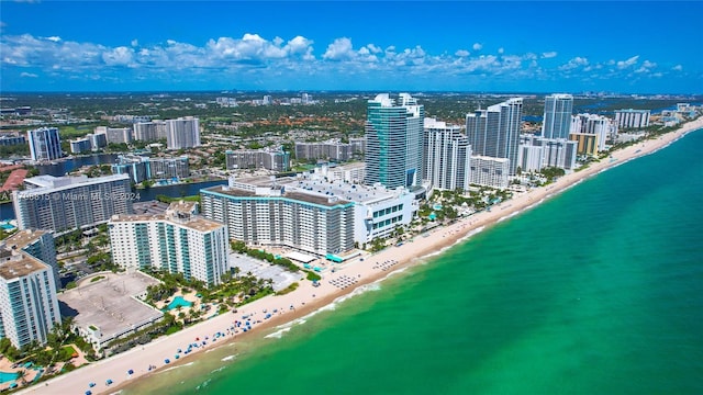 drone / aerial view featuring a beach view and a water view