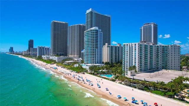 aerial view featuring a view of the beach and a water view