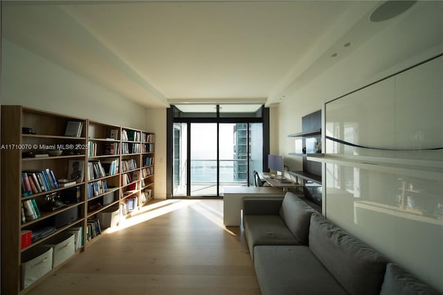 living area featuring expansive windows and light hardwood / wood-style floors