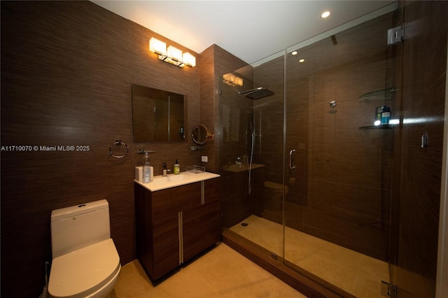 bathroom featuring vanity, toilet, a shower with shower door, and tile patterned flooring