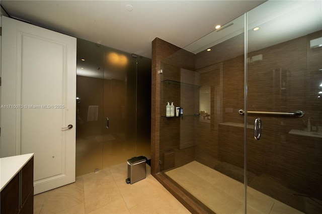 bathroom featuring vanity, tile patterned floors, and a shower with door