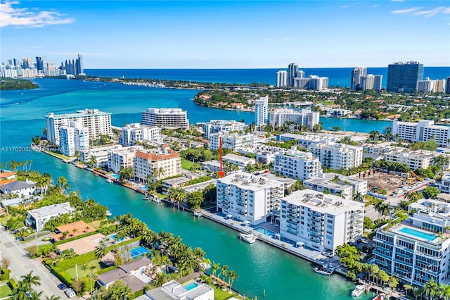 birds eye view of property featuring a city view and a water view