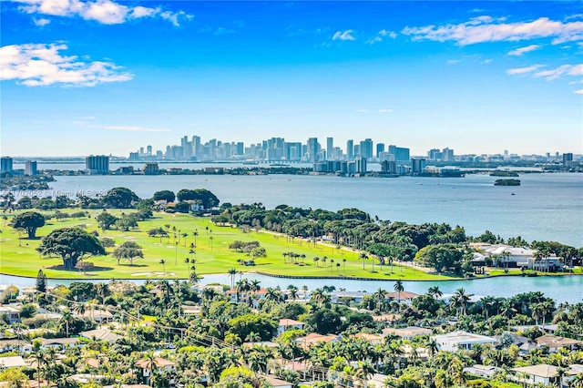 aerial view featuring a water view, view of golf course, and a city view