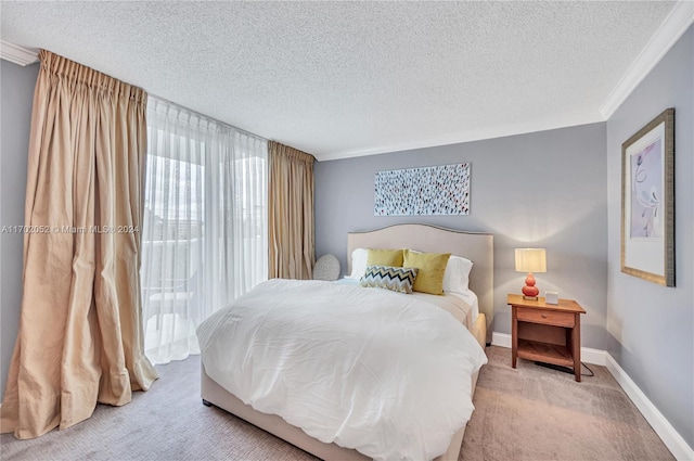 carpeted bedroom with a textured ceiling and crown molding