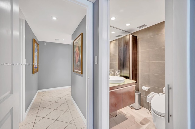 bathroom featuring visible vents, tile patterned flooring, vanity, baseboards, and toilet