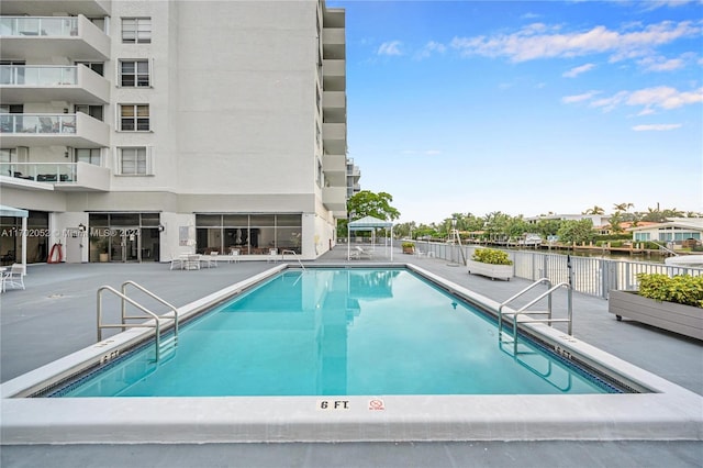 view of swimming pool featuring a patio area