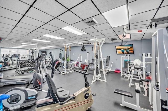 workout area with visible vents and a paneled ceiling