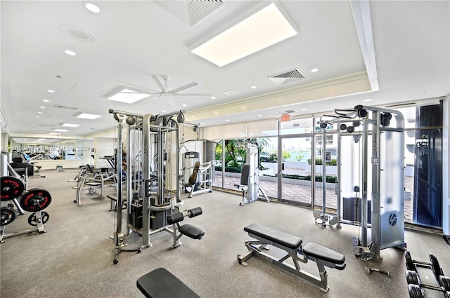 gym featuring ceiling fan and a wall of windows