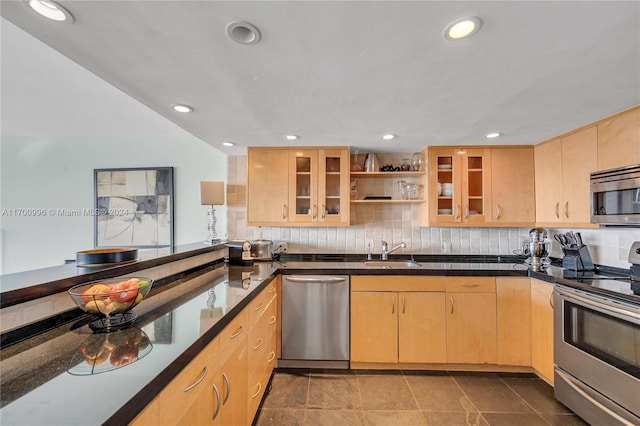 kitchen featuring sink, stainless steel appliances, tasteful backsplash, tile patterned flooring, and light brown cabinetry