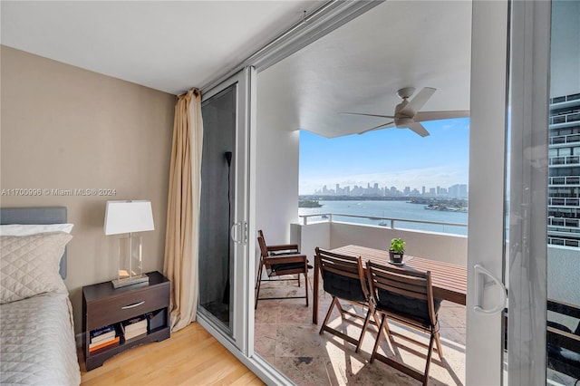 balcony featuring ceiling fan and a water view