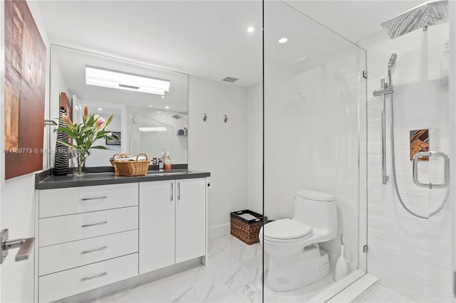 bathroom featuring vanity, toilet, and a shower with shower door