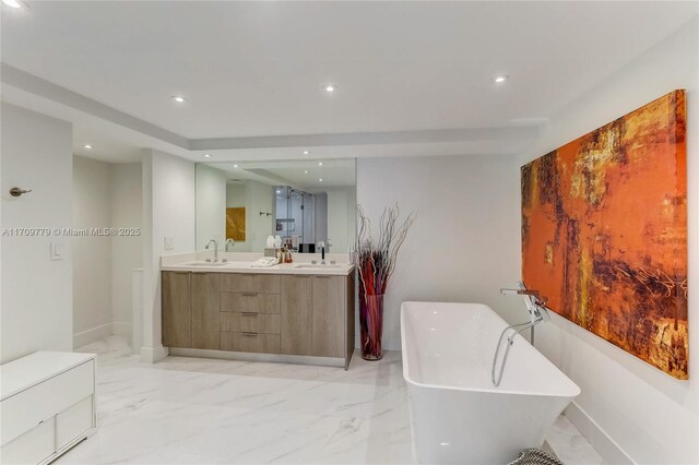 bathroom with a washtub and vanity