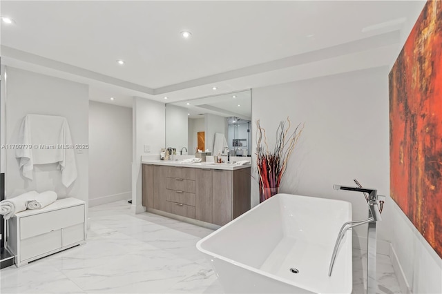 bathroom with a washtub and vanity