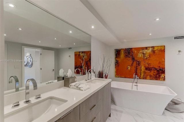 bathroom featuring vanity and a tub