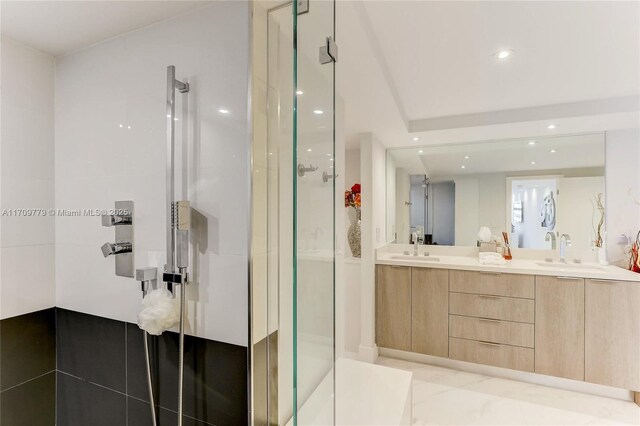 bathroom with vanity and a shower with door