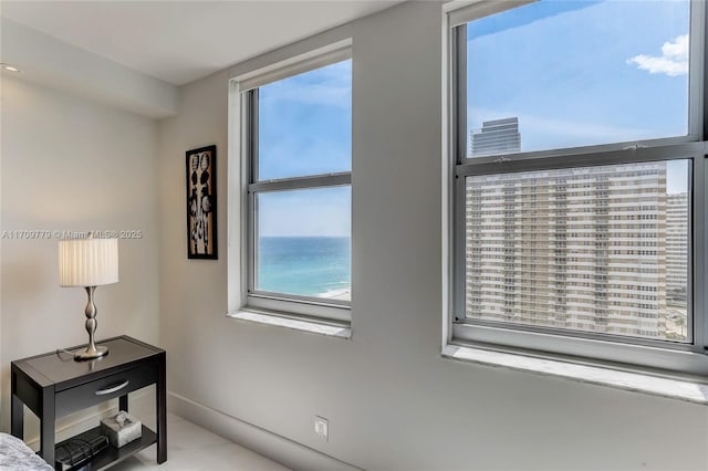 bedroom featuring multiple windows and a water view