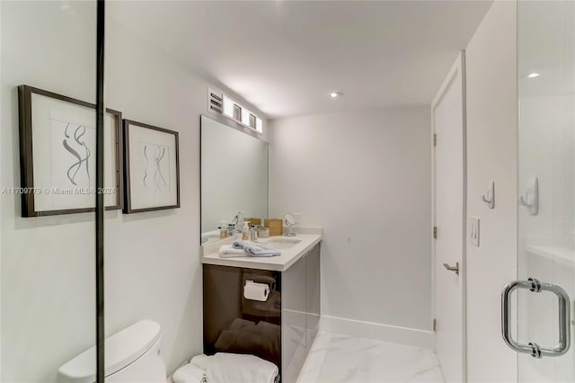 bathroom featuring vanity, toilet, and walk in shower