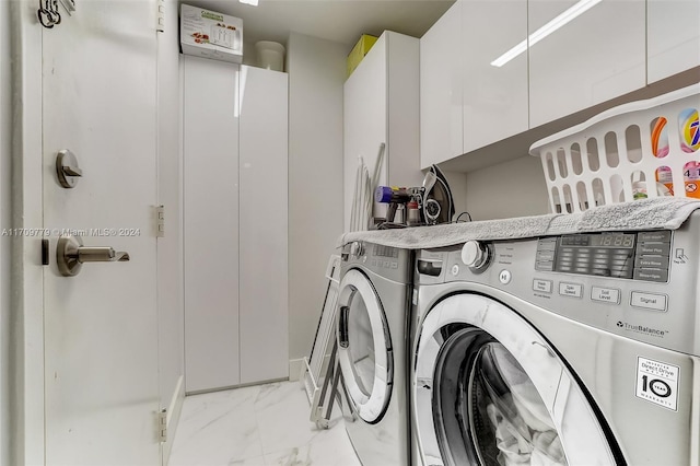 washroom with washing machine and clothes dryer