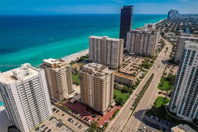 aerial view featuring a water view and a view of the beach