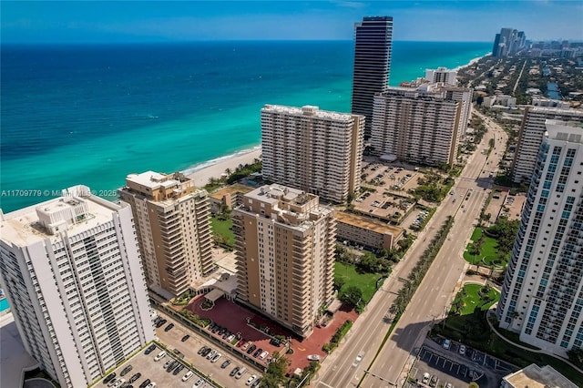 aerial view with a water view and a beach view