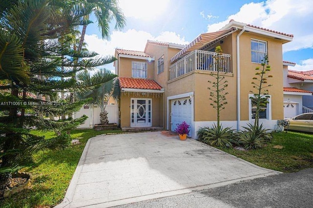 mediterranean / spanish-style home featuring a garage and a balcony