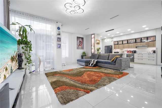 living room with a wealth of natural light and a notable chandelier