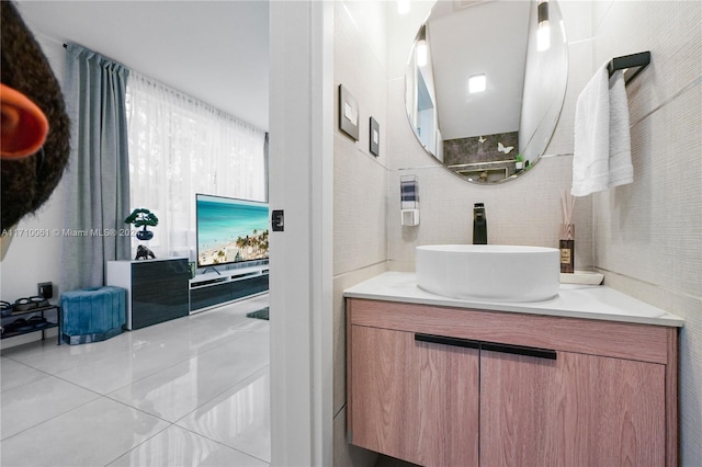 bathroom featuring tile patterned flooring, vanity, and tile walls