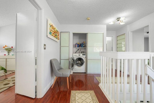 bedroom featuring dark hardwood / wood-style floors, washer / dryer, and a crib