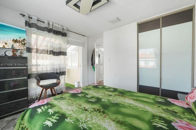 bedroom featuring a textured ceiling and a closet