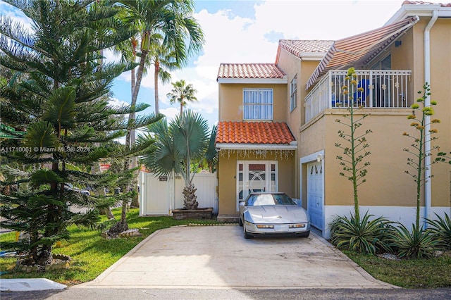 mediterranean / spanish house with a balcony and a garage