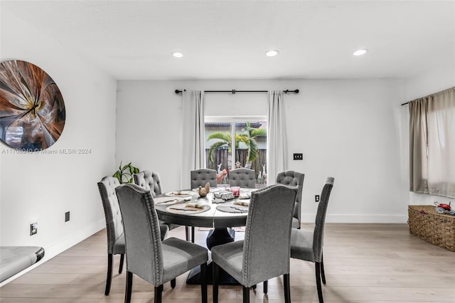 dining space with light hardwood / wood-style floors