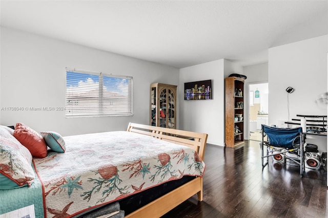 bedroom with dark hardwood / wood-style flooring