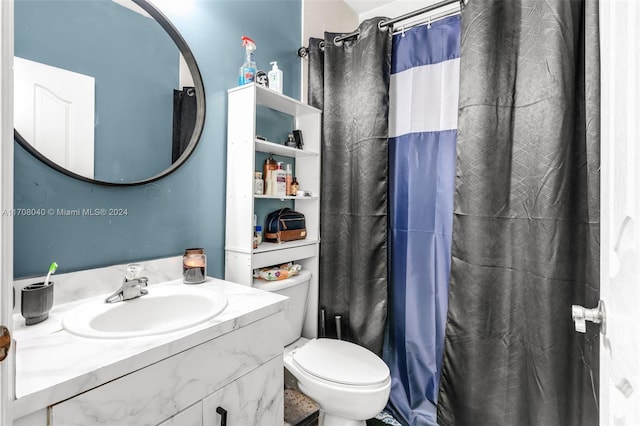 bathroom with vanity, toilet, and walk in shower