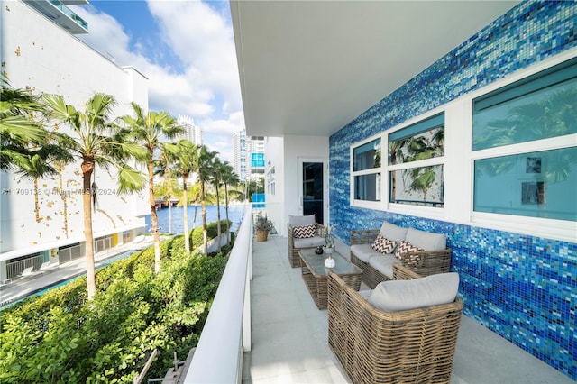 balcony featuring a water view and an outdoor hangout area