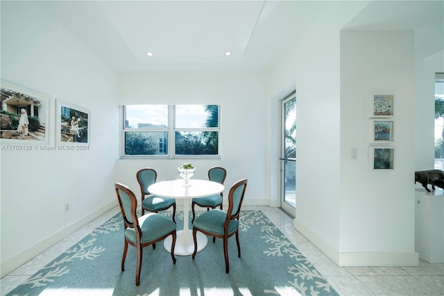 tiled dining space with a wealth of natural light