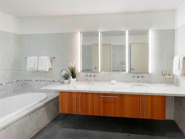 bathroom featuring backsplash, vanity, a bath, and tile walls