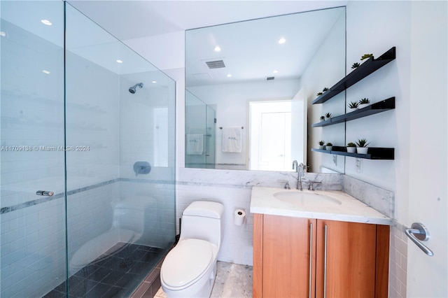 bathroom featuring walk in shower, vanity, and toilet