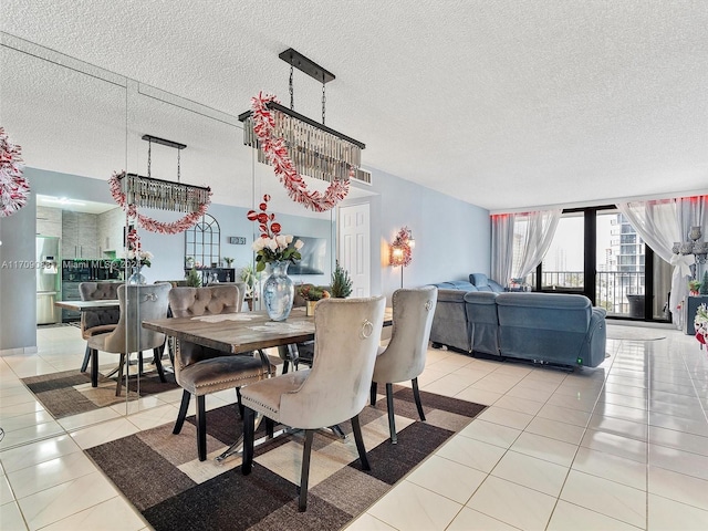 tiled dining space featuring a textured ceiling and a notable chandelier