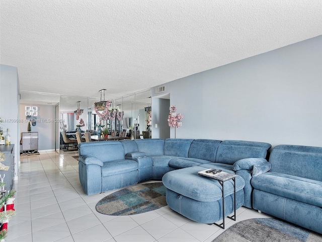 tiled living room featuring a textured ceiling