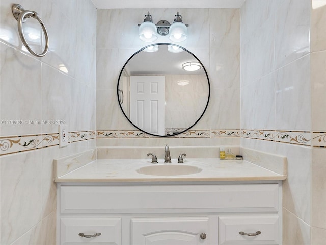 bathroom with vanity and tile walls