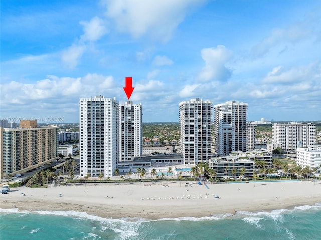 drone / aerial view featuring a view of the beach and a water view