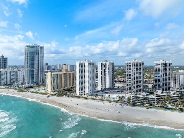 aerial view with a water view and a beach view