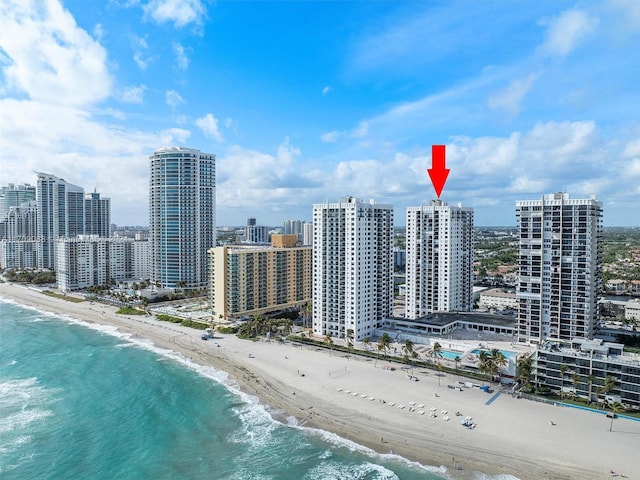 bird's eye view featuring a water view and a beach view