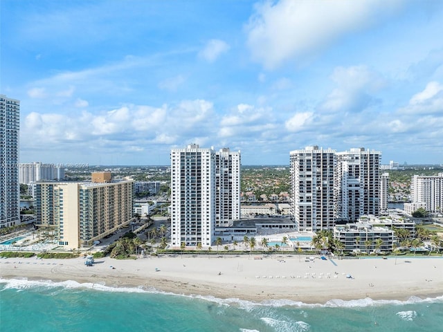 drone / aerial view with a beach view and a water view